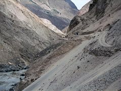 08 Road Though Braldu Gorge To Askole Slants Dangerously Towards The Roaring Braldu River On our seven-hour 117km jeep ride from Skardu to the trailhead at Thongol (2850m), we drove through the 40km Braldu Gorge, where the road is blasted out of the rocks next to the roaring Braldu River. The sickeningly narrow gravel road sometimes slants dangerously towards the Braldu River. You have to withstand being scared constantly for two hours with your life clearly in your driver�s eyes, hands and feet. 'Oh well', I thought. The scariest thing for me was when the jeep had to do three-point turns around hairpin curves. He'd get to the edge with the foaming Braldu River hundreds of metres below, and then reverse back up the hill. 'I hope he knows the reverse gear', I think to myself.